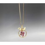 A 9ct gold pendant in the form of an apple set with rubies on a gold box link chain3.7gm
