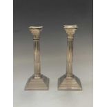 A pair of filled silver classical column candlesticks London 1974 Ht 25.5cm