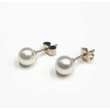 A pair of gold mounted pearl earrings, diameter of each 7mm approx.