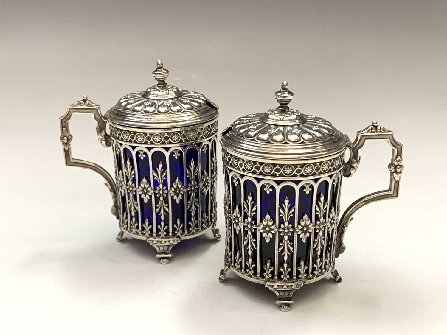 A pair of French silver pierced and embossed mustards with blue glass liners mustard pots 5.8oz