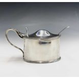 A late Victorian silver mustard pot by Daniel & John Wellby with blue glass liner, and a Georgian