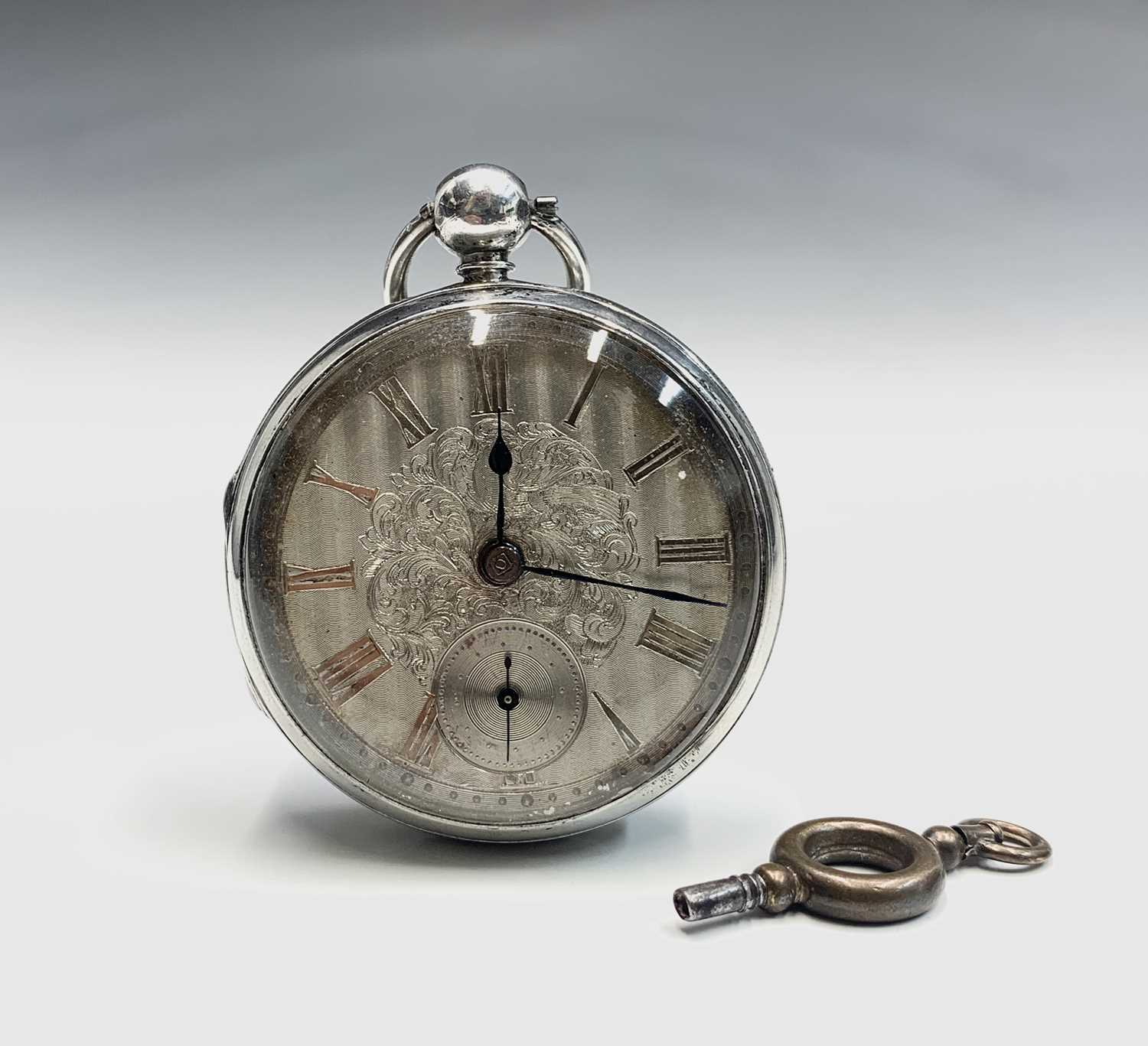 A silver key wind open face pocket watch, hallmarked Birmingham 1839. The face with engraved