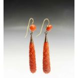 A pair of gold-mounted carved coral drop earrings, 5.4g.