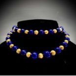 A lapis lazuli and gold bead necklace, 103.6g.Condition report: This modern necklace has beads