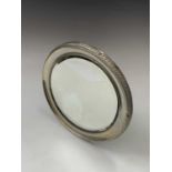 A silver-mounted circular easel dressing table mirror with gadrooned border Birmingham 1911 Dia