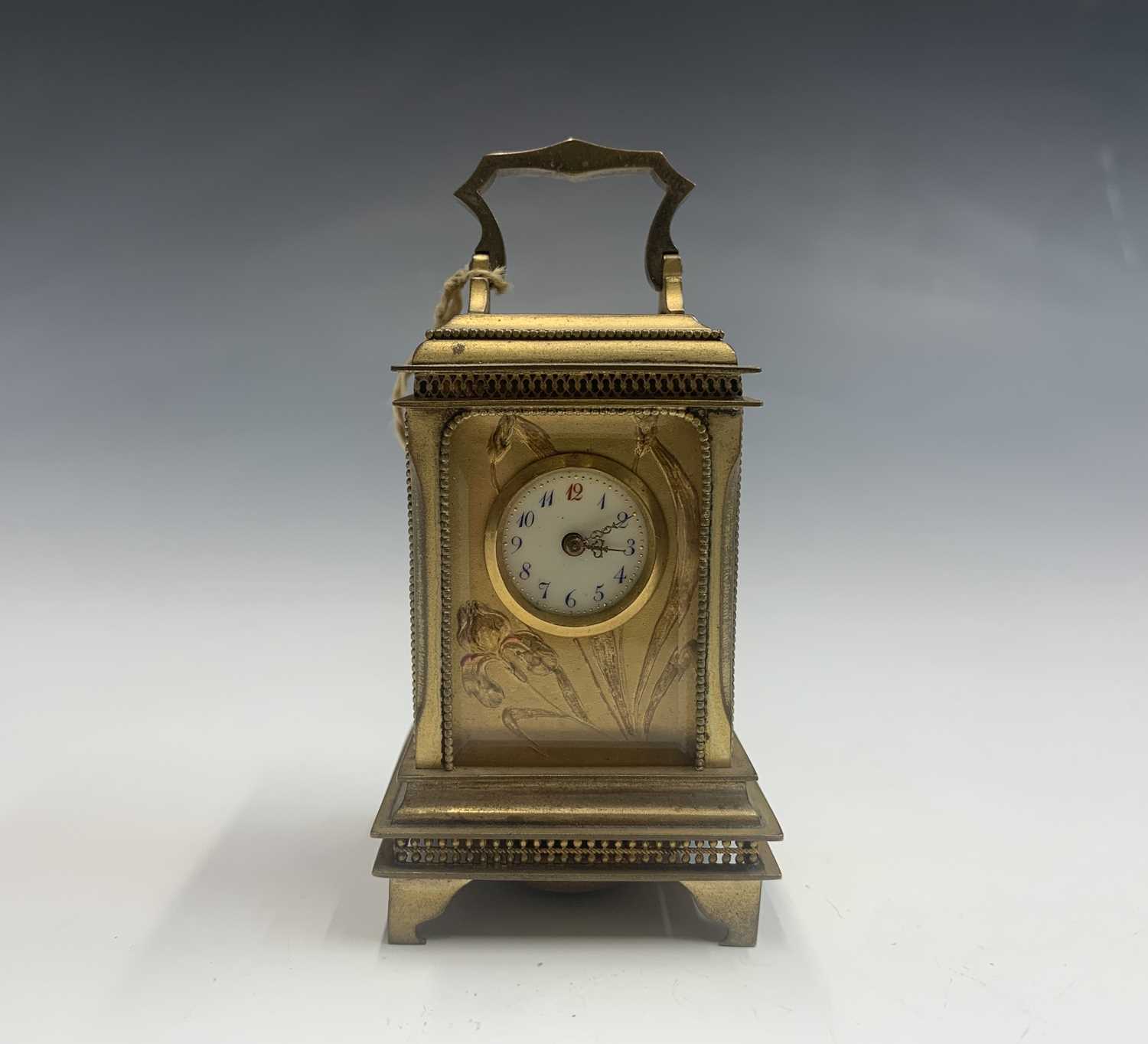 A French Art Nouveau gilt bronze miniature alarm carriage clock.