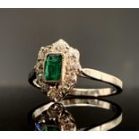 An emerald and diamond cluster ring of pear shape