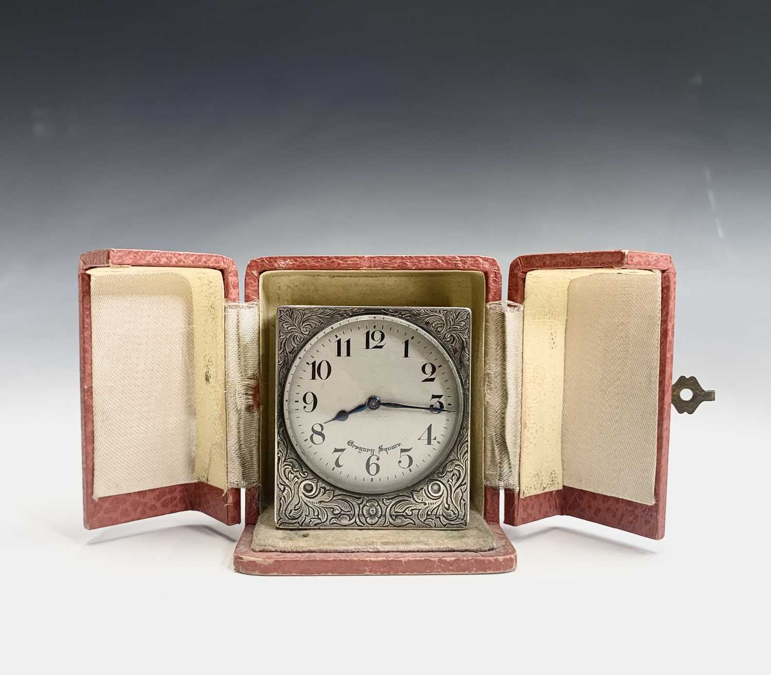 A French square silver carriage clock with engraved decoration to five sides the circular matte