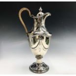 A good Victorian silver wine ewer by Henry Stratford in Adam style and of vase shape embossed with