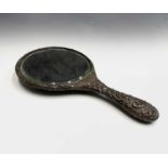 A silver-mounted hand mirror. Worn