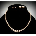 A graduated pearl necklace with 9ct white gold clasp and two pairs of earrings