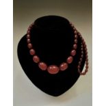 A 'Cherry Amber' necklace, 69gm.