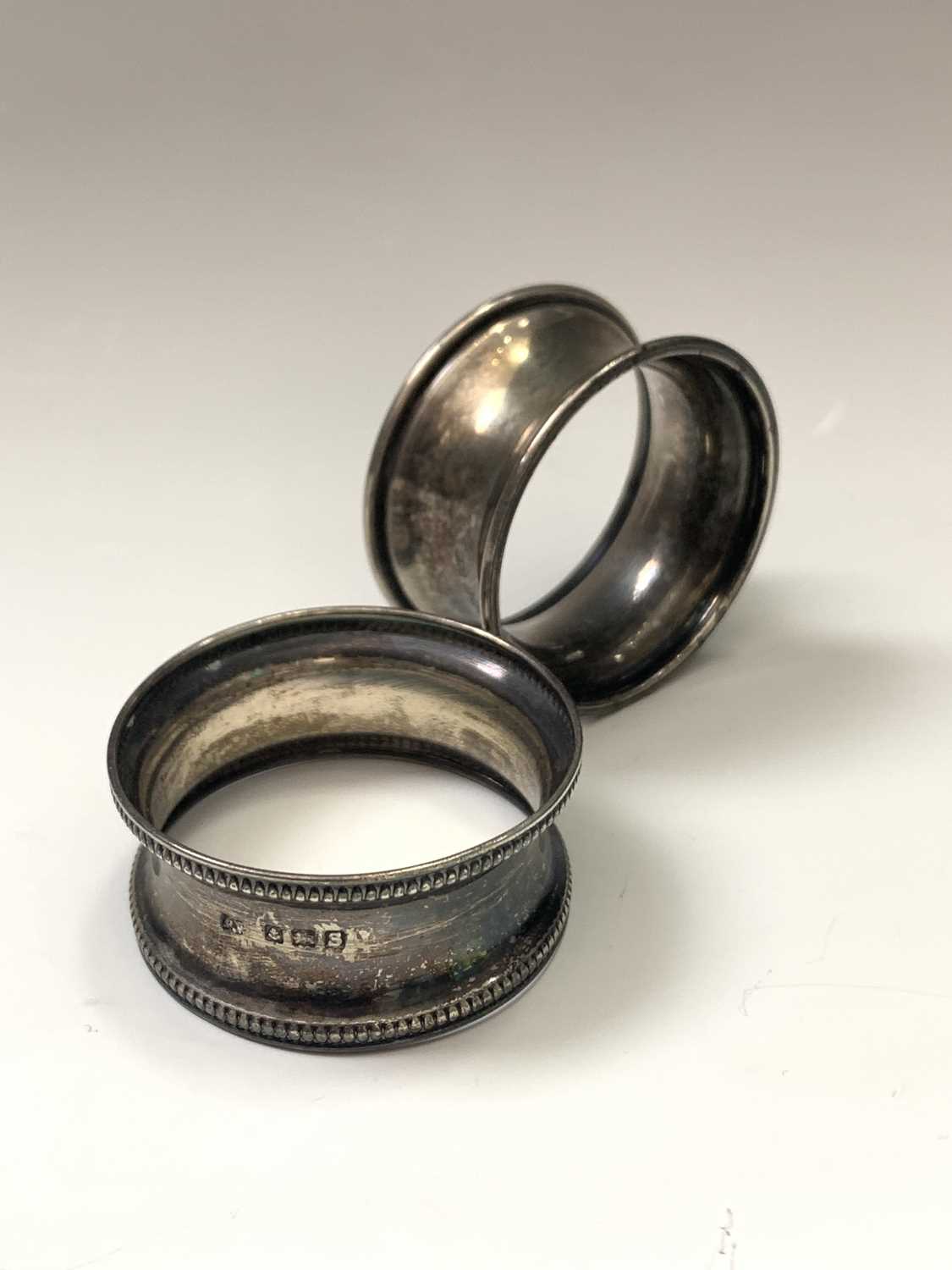 A filled silver capstan inkwell two silver napkin rings and an EPNS box