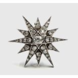 A Victorian diamond set star brooch, the central stone of approximately .75ct spread, screw on