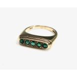 A stylish 18ct gold five stone emerald ring London 1985 6.9gm.Approx size: N1/2