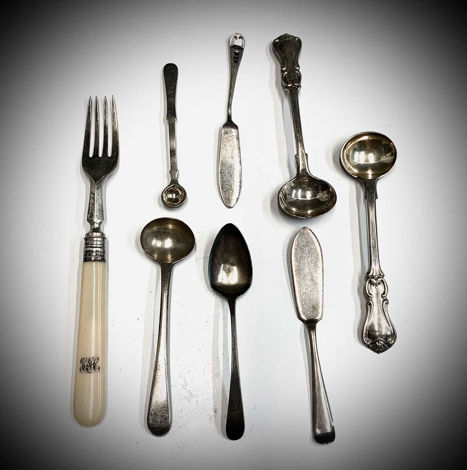A pair of Victorian silver salt spoons, three other spoons two butterknives and a fork
