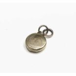 A Victorian tiny gold locket with swirl engine turning Dia 13mm