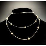 A platinum long chain with pearls spaced out along its length 18ct gold clip 9.8gm