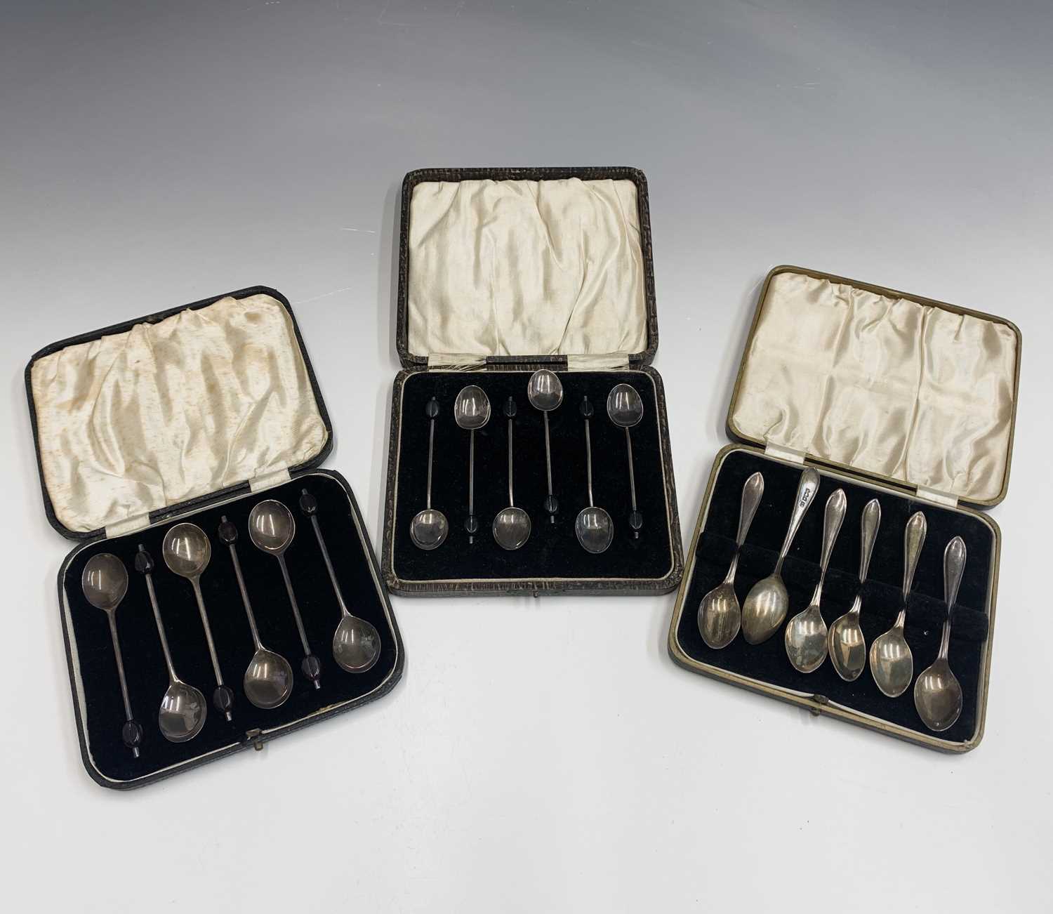 Two sets of six silver bean knop coffee spoons, cased and one other cased set of six silver coffee