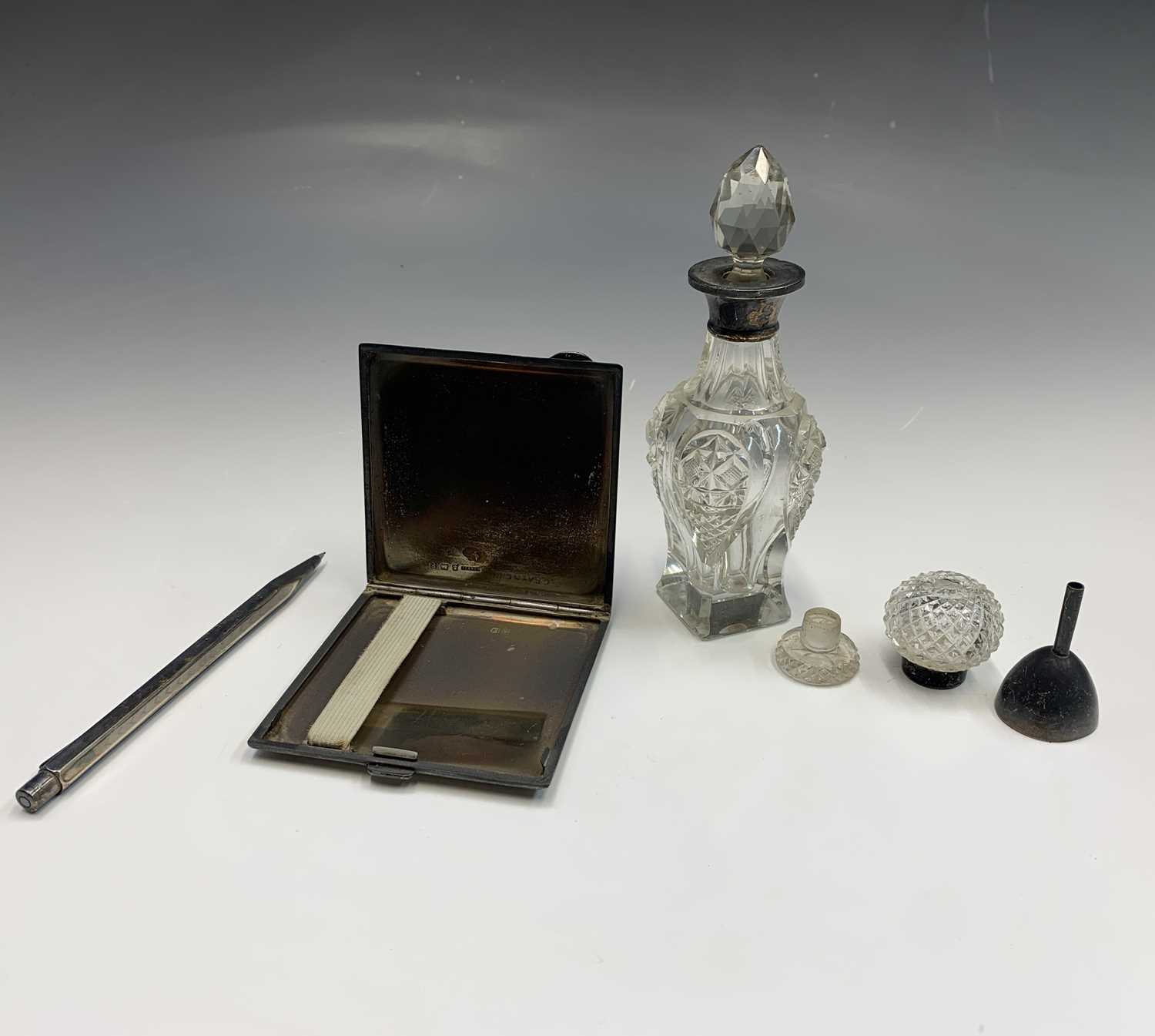 A silver cigarette case 3.70z together with two silver-mounted bottles, an unmarked pencil and an