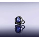 An impressive tanzanite and diamond cluster ring set in platinum.Approx size: P