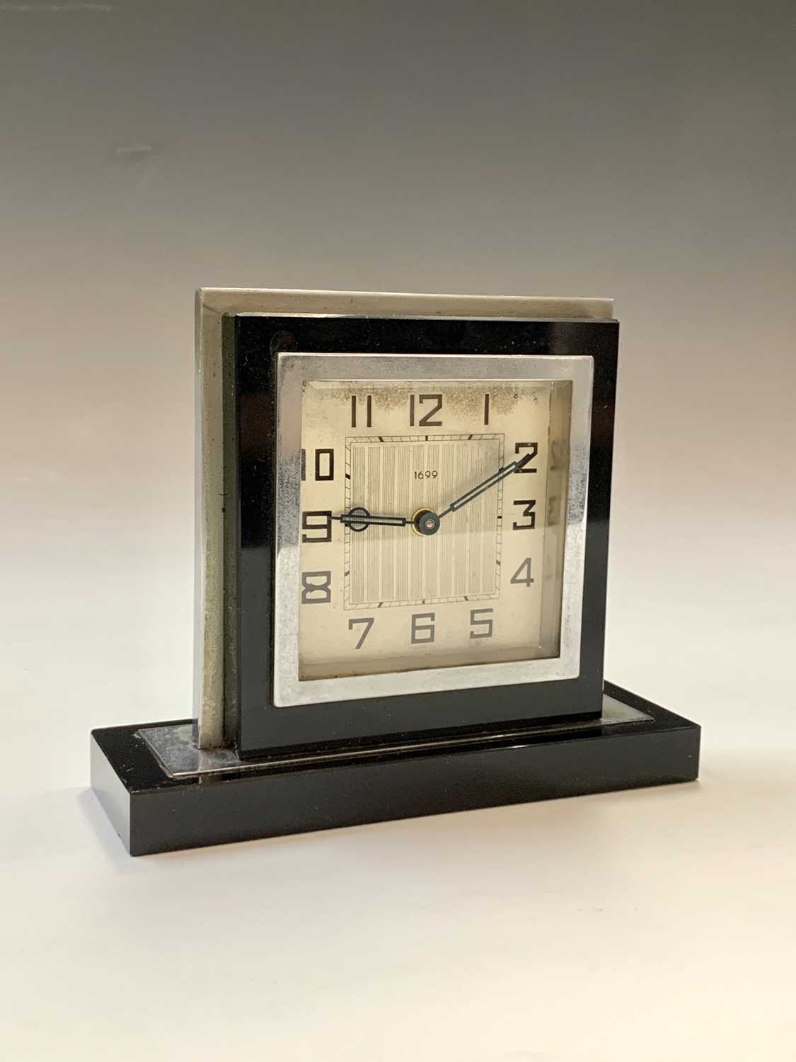 A black glass and nickel plated Art Deco clock. H: 12cm.