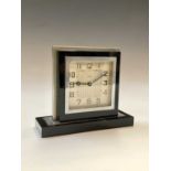 A black glass and nickel plated Art Deco clock. H: 12cm.