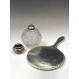 An engine-turned silver-mounted hand mirror, a Japanese cast white metal toilet jar with silver