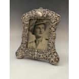 An extremely ornate late Victorian or Edwardian photograph frame with putti and a vine trellis 21
