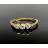 An 18ct gold three stone diamond ring.Condition report: 1.9gm These small rose-cut diamonds don't