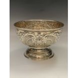 A handsome large footed Edwardian bowl with rococo embossed decoration and vacant cartouche by