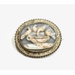 A fine Victorian gold brooch set with a striated shell cameo carved with the Pliny Doves Hair