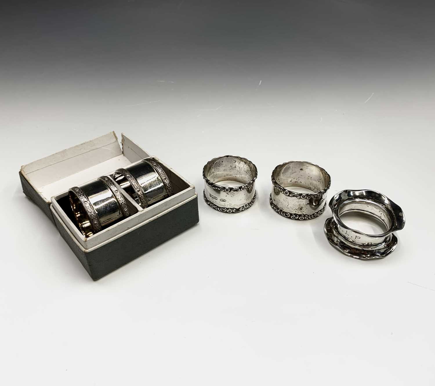 Two pairs of silver napkin rings and a fifth silver napkin ring 4.5oz