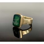 A 9ct gold signet ring, the finely carved green rectangular intaglio with a bird within a crown.