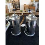 A pair of silver pots, one for coffee the other hot water, by the Goldsmiths & Silversmiths Co.