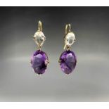 A pair of gold-mounted white stone and amethyst drop earings, 5.3g.