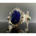 A silver Mexican style lapis and matrix turquoise bangle, 67gm unmarked