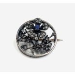 A 19th-century French circle brooch with a flowering plant set with diamonds and sapphires Dia