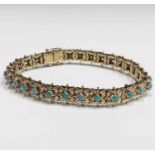 An 18ct gold bracelet set to the square flowerhead links with 29 turquoise 19.5gm