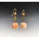 A pair of Chinese carved pink coral sphere earrings, with pierced gold spacers and gold hooks, 7.