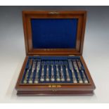 A set of eighteen dessert knives and forks with hallmarked filled silver handles, in mahogany case