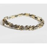 An Italian 14ct yellow and white gold diamond set bracelet. 13.9gm.