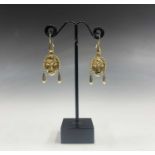 A pair of high purity gold tribal mask earrings, 9gm.