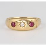 An 18ct yellow gold ruby and diamond 3 stone ring, size I, 2.6 grams