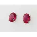A pair of silver and treated ruby ear studs