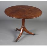 A 19th Century mahogany circular snap top tea table raised on a turned column and tripod base with
