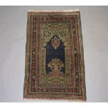 A blue and green ground Persian Prayer rug within multi row border 133cm x 80cm Fringe missing, some
