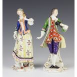 A pair of early 20th Century Continental figures of a lady and gentleman holding masks 19cm Both