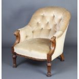 A Victorian bleached mahogany tub back chair upholstered in mushroom buttoned material, raised on