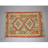A yellow and green ground wool Chobi Kilim rug with 2 diamonds to the centre 120cm x 79cm